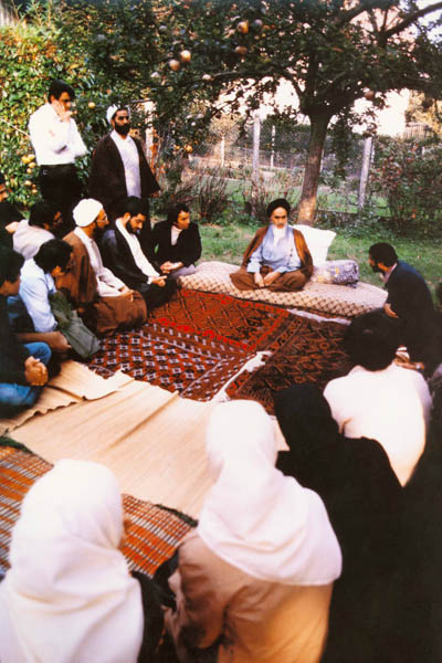 امام نشسته در حیاط در میان دیدارکنندگان در نوفل لوشاتو